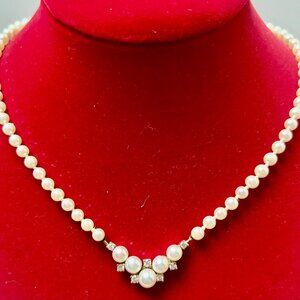 White cultured pearl and round brilliant Diamond 14k yellow gold necklace.